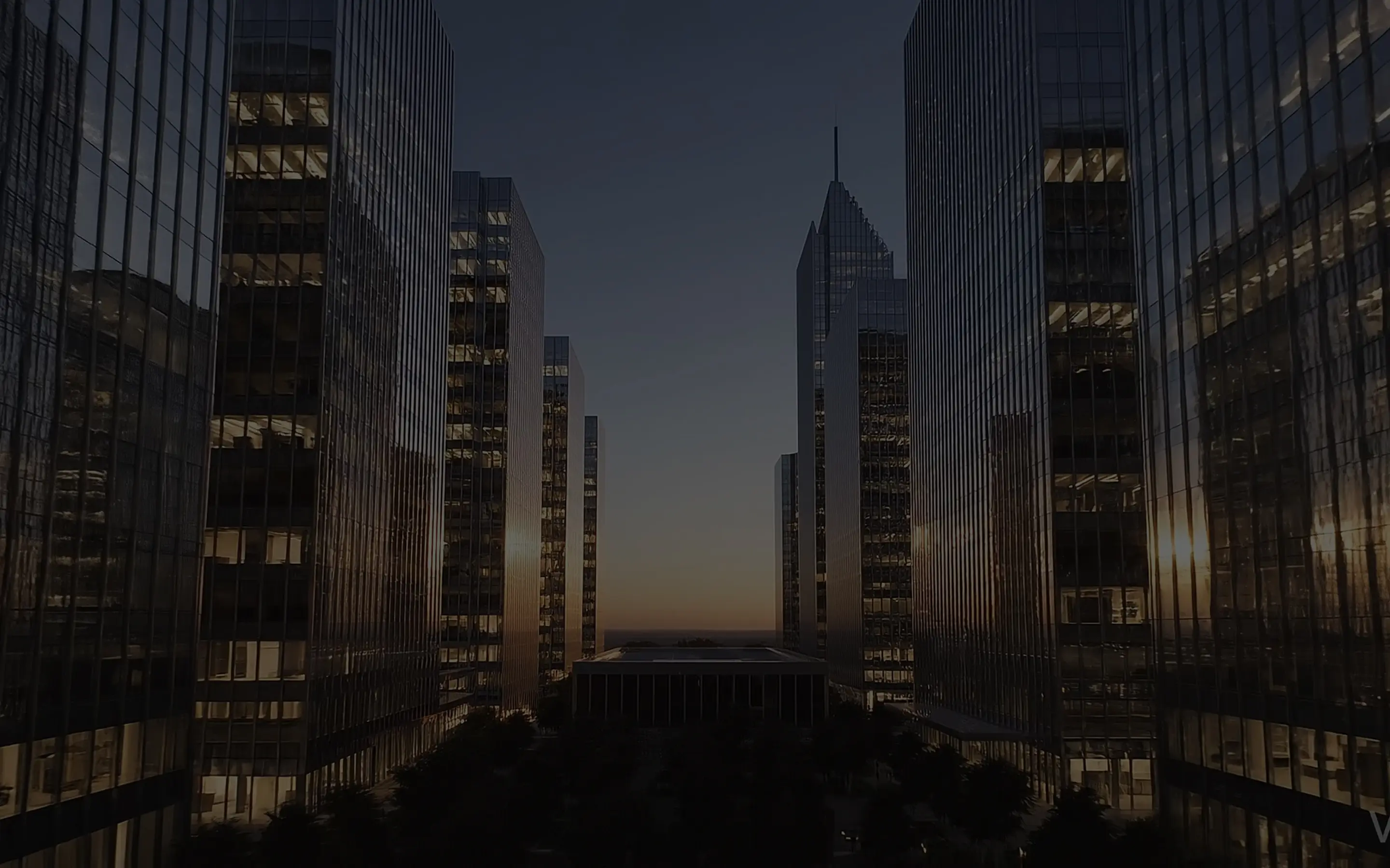 Modern buildings in an urban setting at dusk.