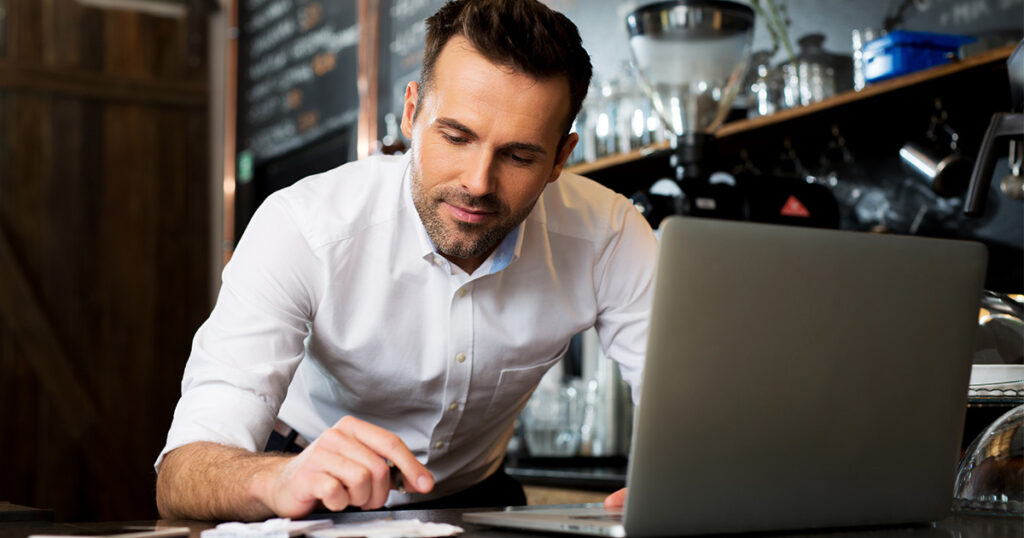 Small restaurant owner going through receipts for his financial records